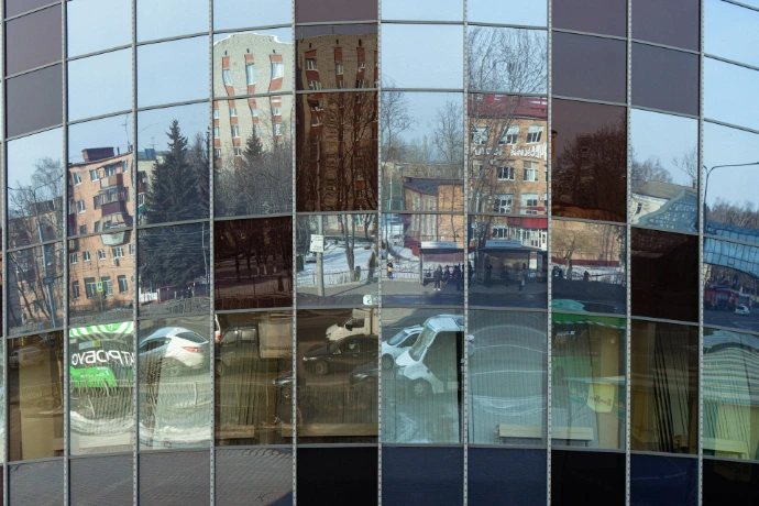 the reflection of buildings in the windows of a building